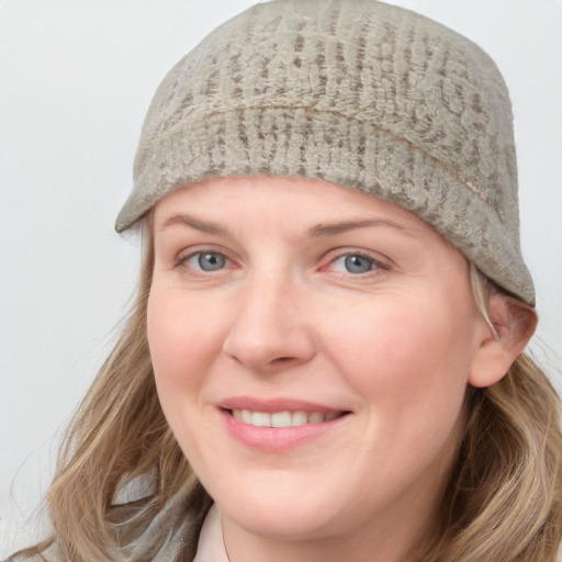 Joyful white young-adult female with medium  brown hair and blue eyes