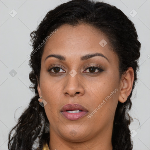 Joyful black young-adult female with long  brown hair and brown eyes