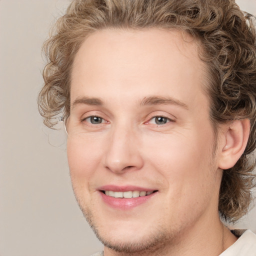 Joyful white young-adult male with medium  brown hair and brown eyes