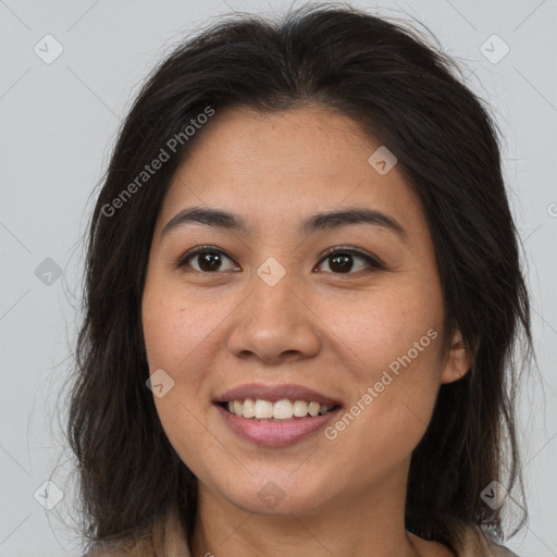 Joyful latino young-adult female with long  brown hair and brown eyes