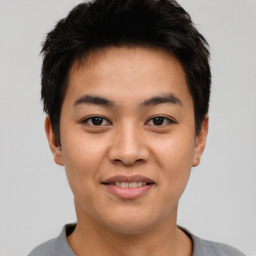 Joyful asian young-adult male with short  brown hair and brown eyes