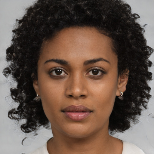 Neutral black young-adult female with medium  brown hair and brown eyes