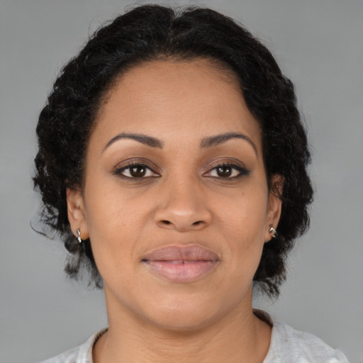 Joyful latino young-adult female with medium  brown hair and brown eyes