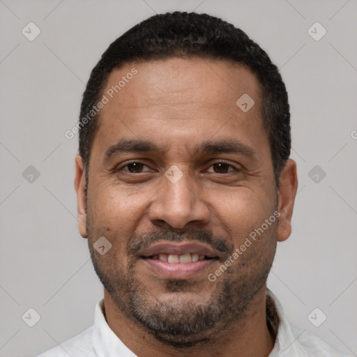 Joyful latino adult male with short  black hair and brown eyes