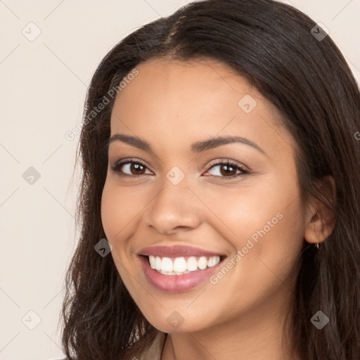 Joyful latino young-adult female with long  brown hair and brown eyes