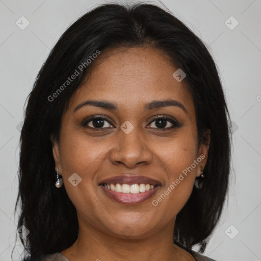 Joyful black adult female with long  brown hair and brown eyes