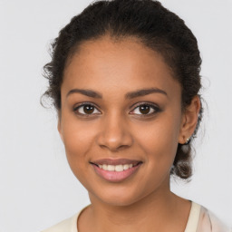 Joyful latino young-adult female with long  brown hair and brown eyes