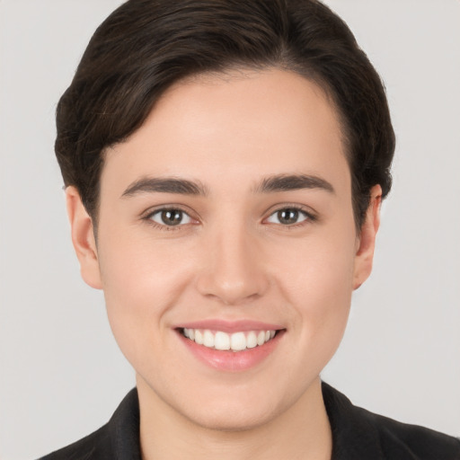 Joyful white young-adult female with short  brown hair and brown eyes