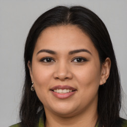 Joyful latino young-adult female with long  brown hair and brown eyes