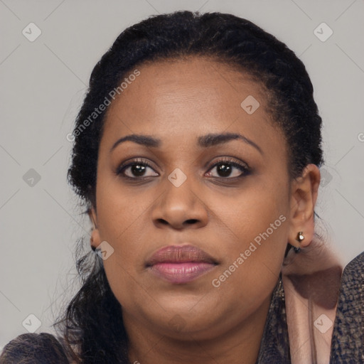 Joyful black young-adult female with long  black hair and brown eyes