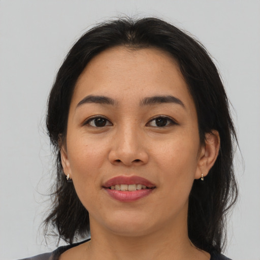 Joyful asian young-adult female with medium  brown hair and brown eyes