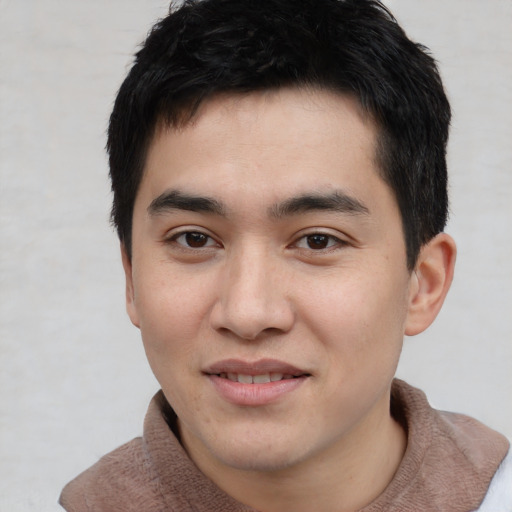 Joyful asian young-adult male with short  brown hair and brown eyes