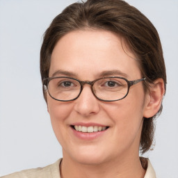 Joyful white adult female with medium  brown hair and grey eyes