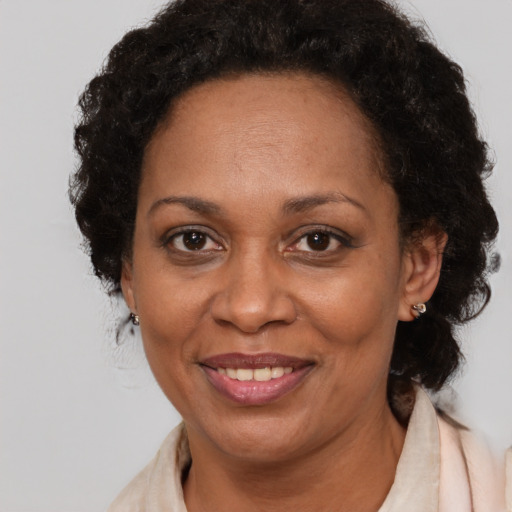 Joyful black adult female with short  brown hair and brown eyes