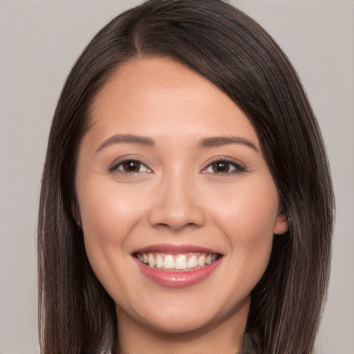 Joyful white young-adult female with long  brown hair and brown eyes