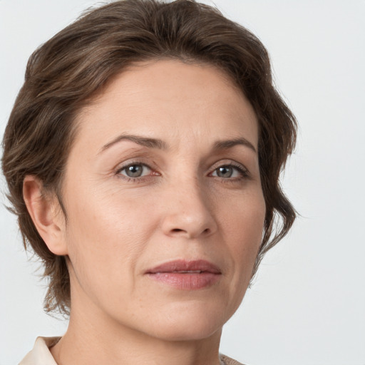 Joyful white adult female with medium  brown hair and grey eyes