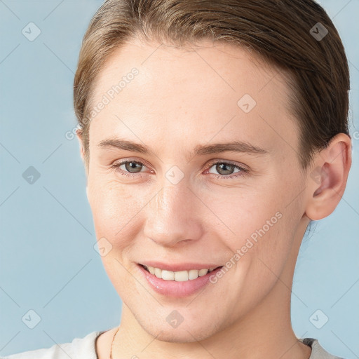 Joyful white young-adult female with short  brown hair and brown eyes