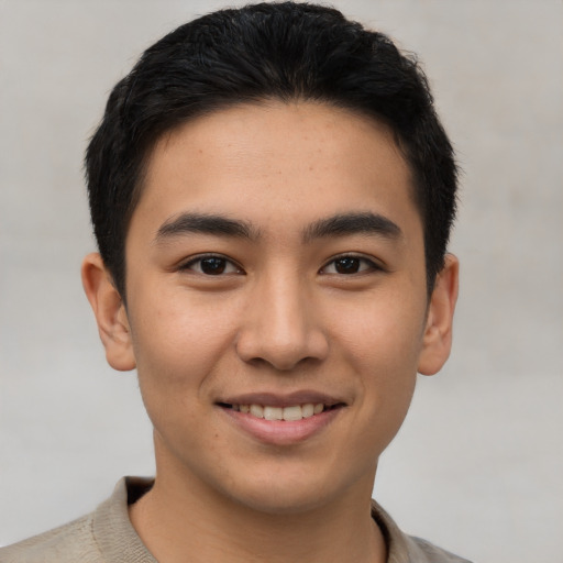 Joyful asian young-adult male with short  brown hair and brown eyes