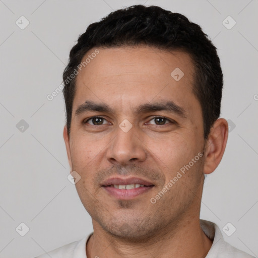 Joyful white young-adult male with short  black hair and brown eyes