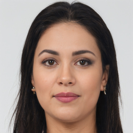 Joyful latino young-adult female with long  brown hair and brown eyes