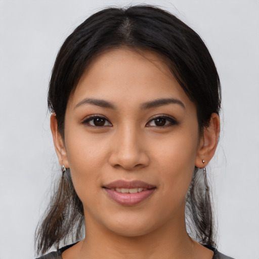 Joyful latino young-adult female with medium  brown hair and brown eyes