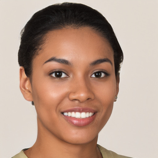 Joyful latino young-adult female with short  black hair and brown eyes