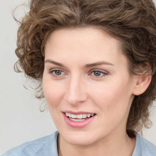 Joyful white young-adult female with medium  brown hair and blue eyes