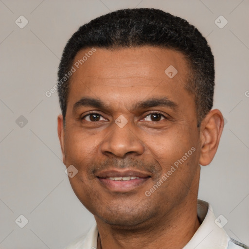 Joyful latino adult male with short  black hair and brown eyes