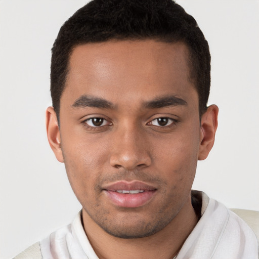 Joyful black young-adult male with short  brown hair and brown eyes