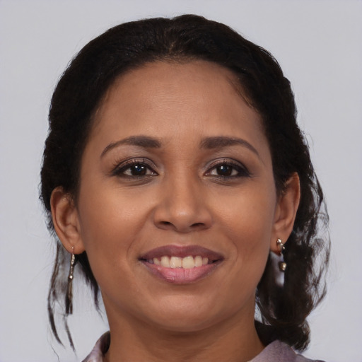Joyful black young-adult female with medium  brown hair and brown eyes
