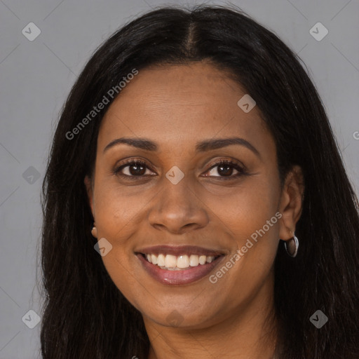 Joyful black young-adult female with long  brown hair and brown eyes