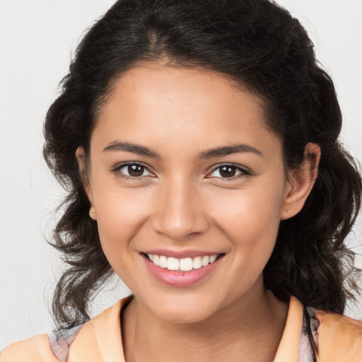 Joyful latino young-adult female with medium  brown hair and brown eyes