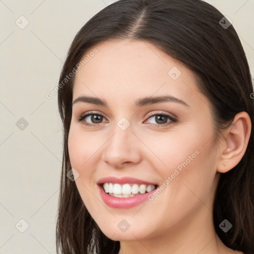 Joyful white young-adult female with long  brown hair and brown eyes