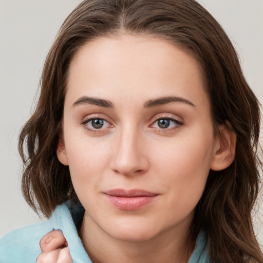 Joyful white young-adult female with long  brown hair and green eyes