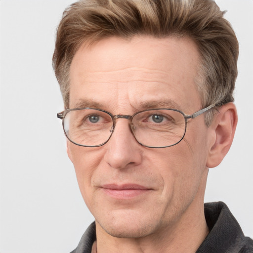 Joyful white middle-aged male with short  brown hair and grey eyes