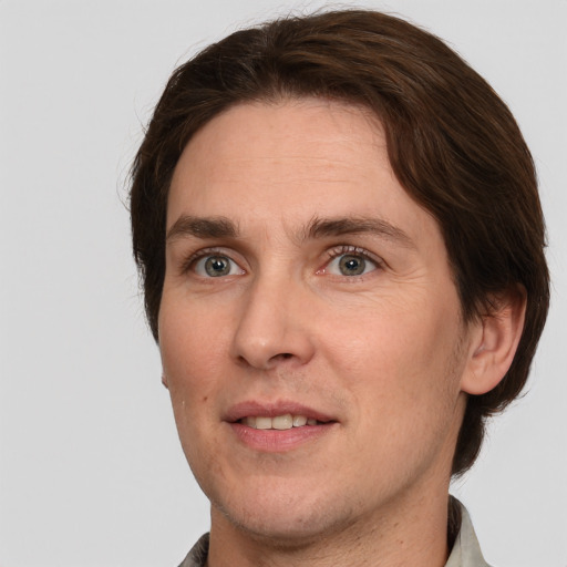 Joyful white adult male with short  brown hair and grey eyes