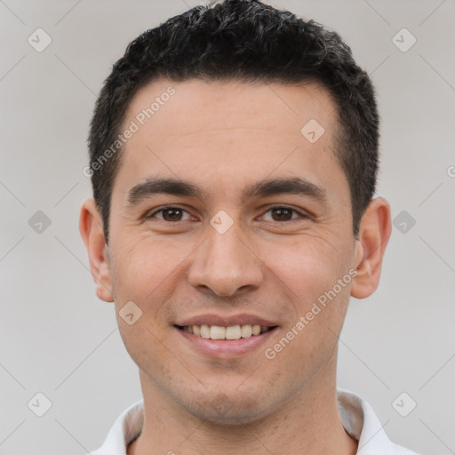 Joyful white young-adult male with short  black hair and brown eyes