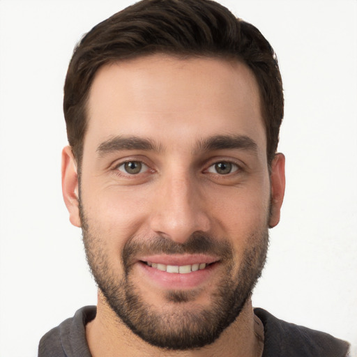 Joyful white young-adult male with short  brown hair and brown eyes