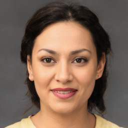 Joyful latino young-adult female with medium  brown hair and brown eyes