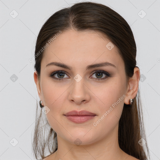 Joyful white young-adult female with long  brown hair and grey eyes