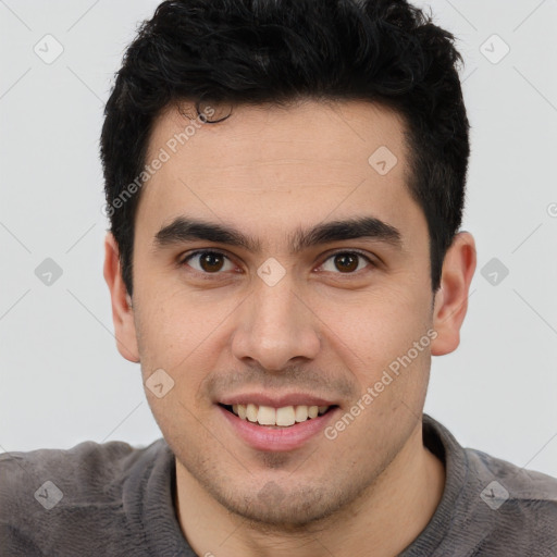 Joyful latino young-adult male with short  brown hair and brown eyes