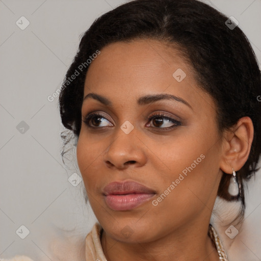 Joyful black young-adult female with long  brown hair and brown eyes