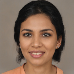 Joyful latino young-adult female with medium  brown hair and brown eyes