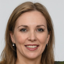 Joyful white adult female with medium  brown hair and grey eyes