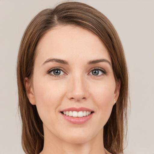 Joyful white young-adult female with medium  brown hair and green eyes