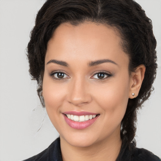 Joyful white young-adult female with long  brown hair and brown eyes