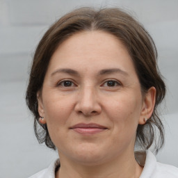 Joyful white adult female with medium  brown hair and brown eyes