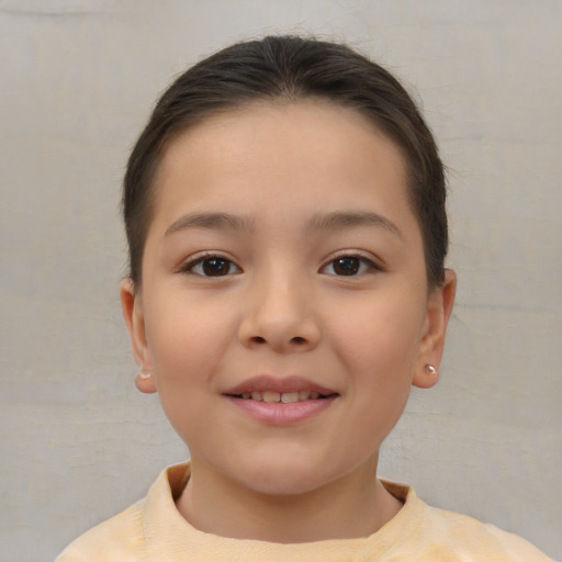 Joyful white child female with short  brown hair and brown eyes