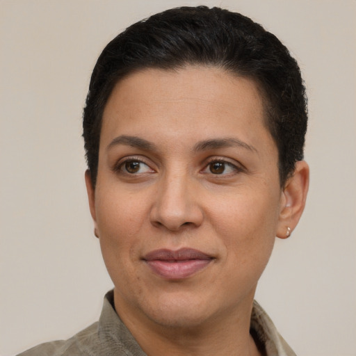 Joyful latino adult female with short  brown hair and brown eyes