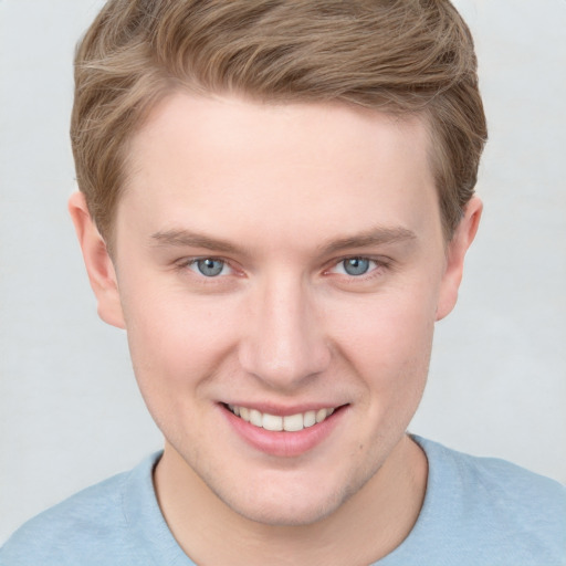 Joyful white young-adult male with short  brown hair and blue eyes